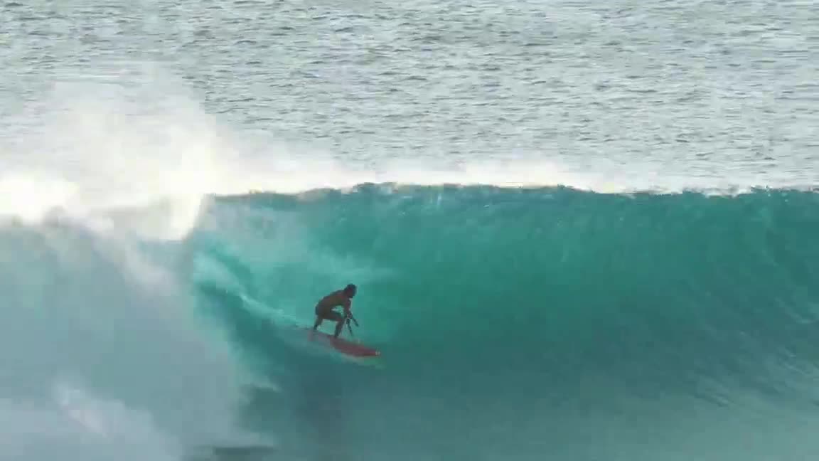 Surfer in the pocket of a clean open wave
